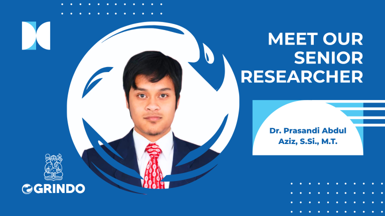 Foto resmi Dr. Prasandi Abdul Aziz, S.Si., M.T., senior researcher di Ogrindo ITB mengenakan jas formal dengan latar design grafis biru